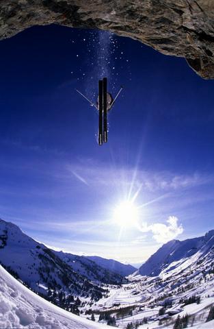 Skier jumping off a cliff at Alta in Utah
