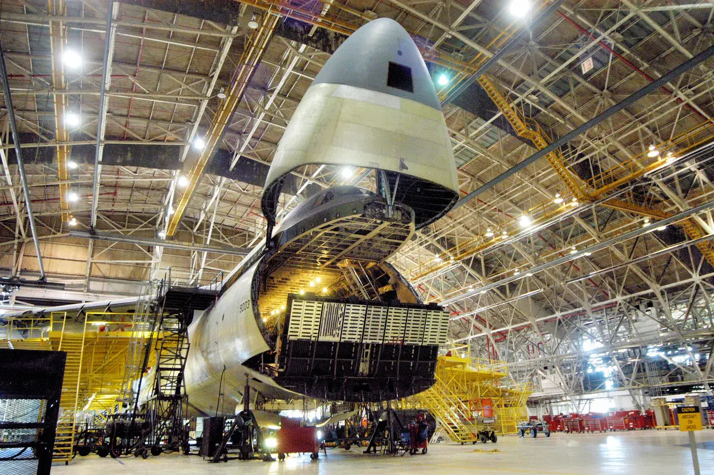 C-5 Galaxy with its nose raised for modification in a hangar at the Warner Robins Air Logistics Complex, Robins Air Force Base